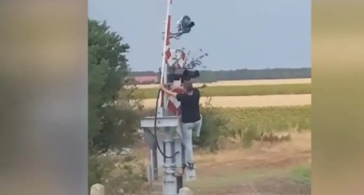 Imagini inedite: Mecanic de tren coboară manual bariera la trecerea de cale ferată în Teleorman