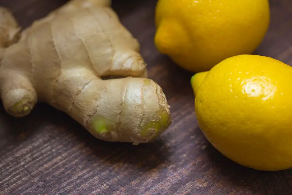 A glass of ginger shot with lemon and mint leaves on a wooden table